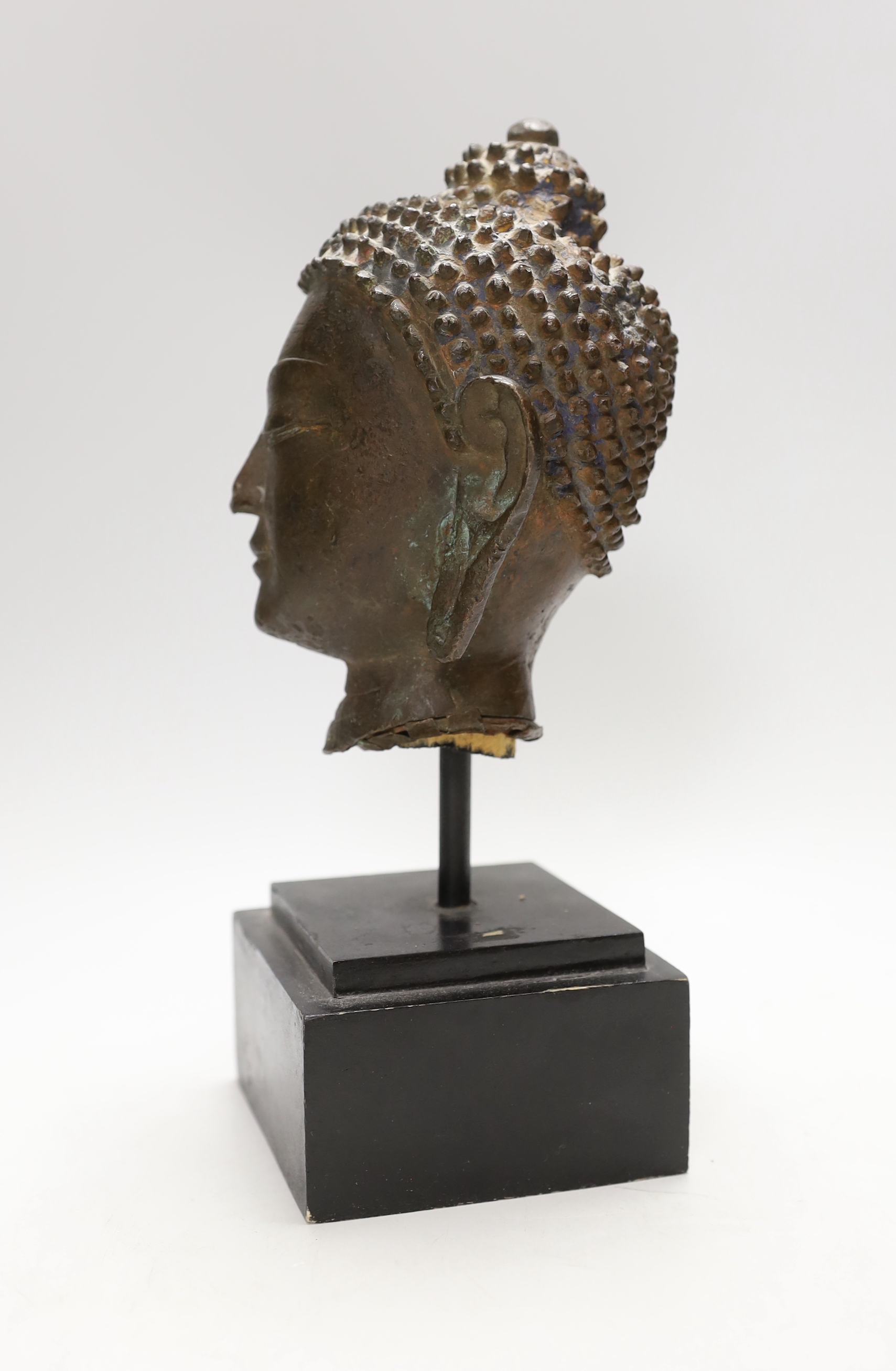 A Thai bronze Buddha head, cast bronze on stand, 17th/28th century century, vendor states belonged to Alexander McQueen, 27cm